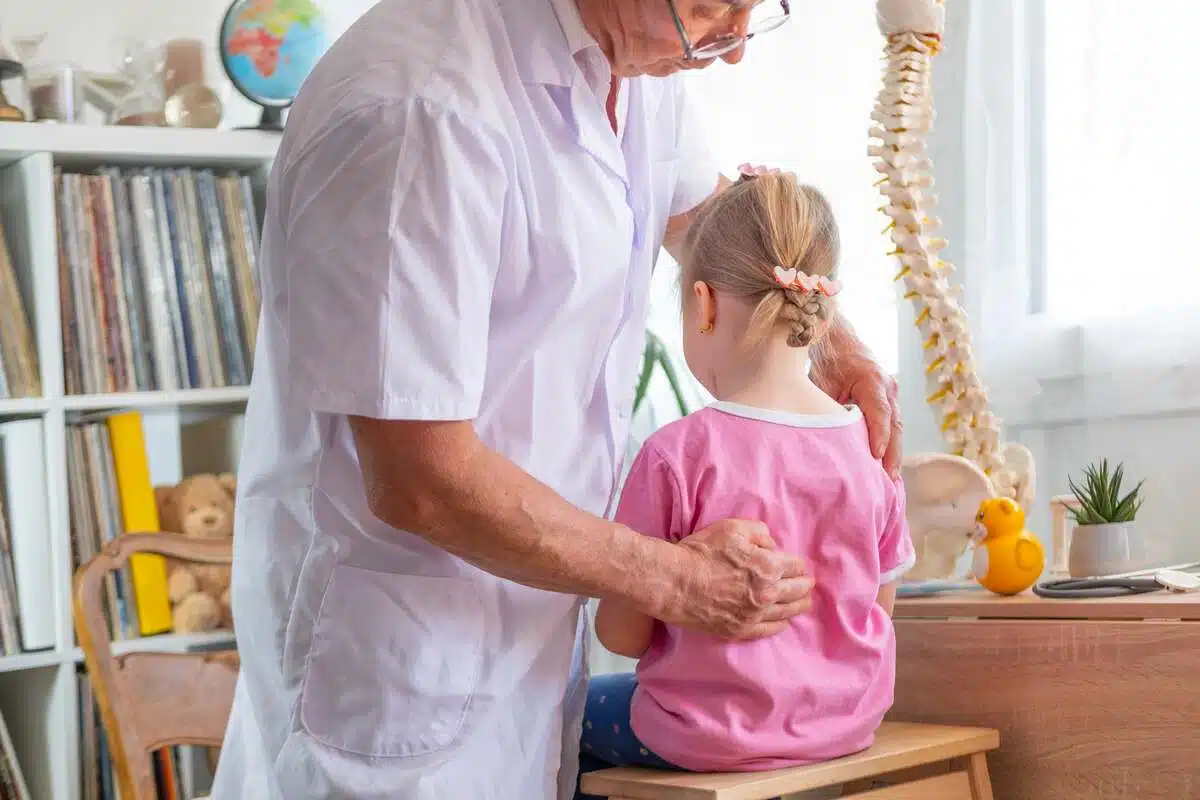 A pediatrician checking his female patient