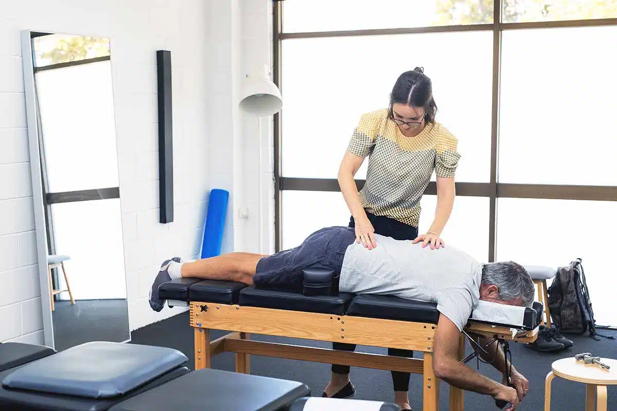 Man having chiropractic back adjustment. Physioterapy, osteopathy, alternative medicine pain relief rehabilitation